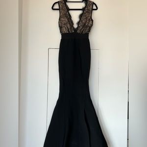 Formal black dress with lace detail.